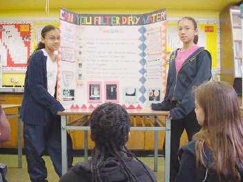 Stephanie & Michelle explain their science fair project to class...